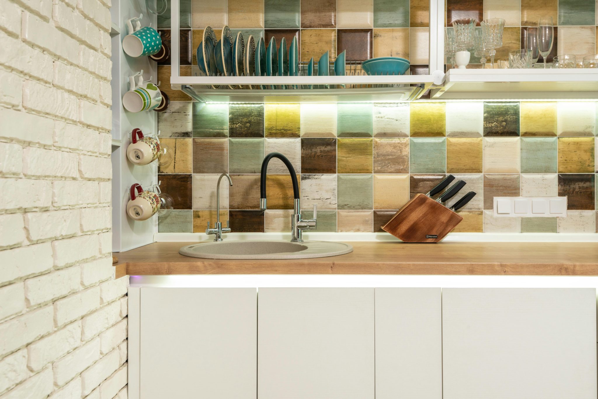 a kitchen with multicoloured tiles