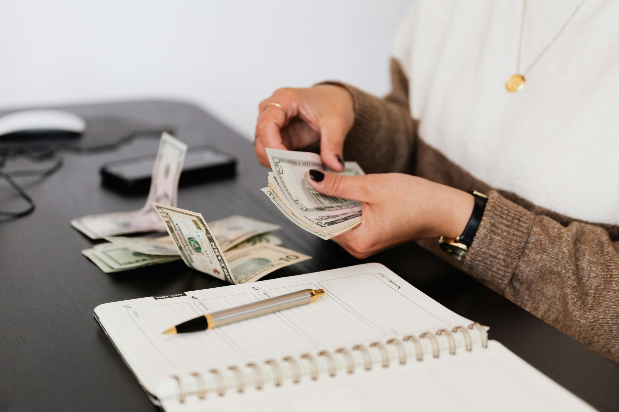 someone counting cash at a desk