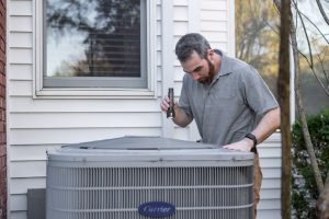 person checks HVAC system
